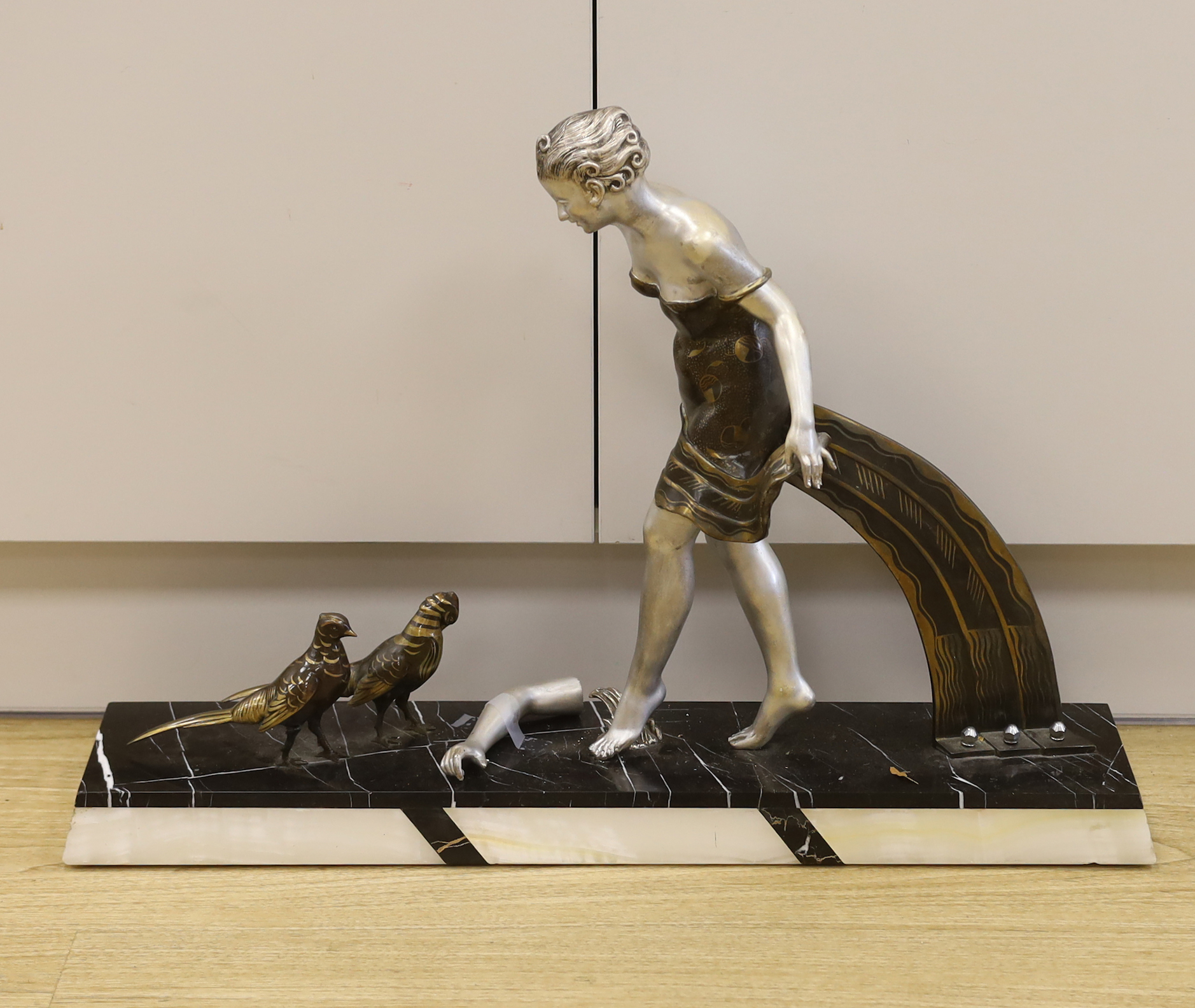 A French Art Deco spelter and marble figure group, 49cm tall (a.f.)